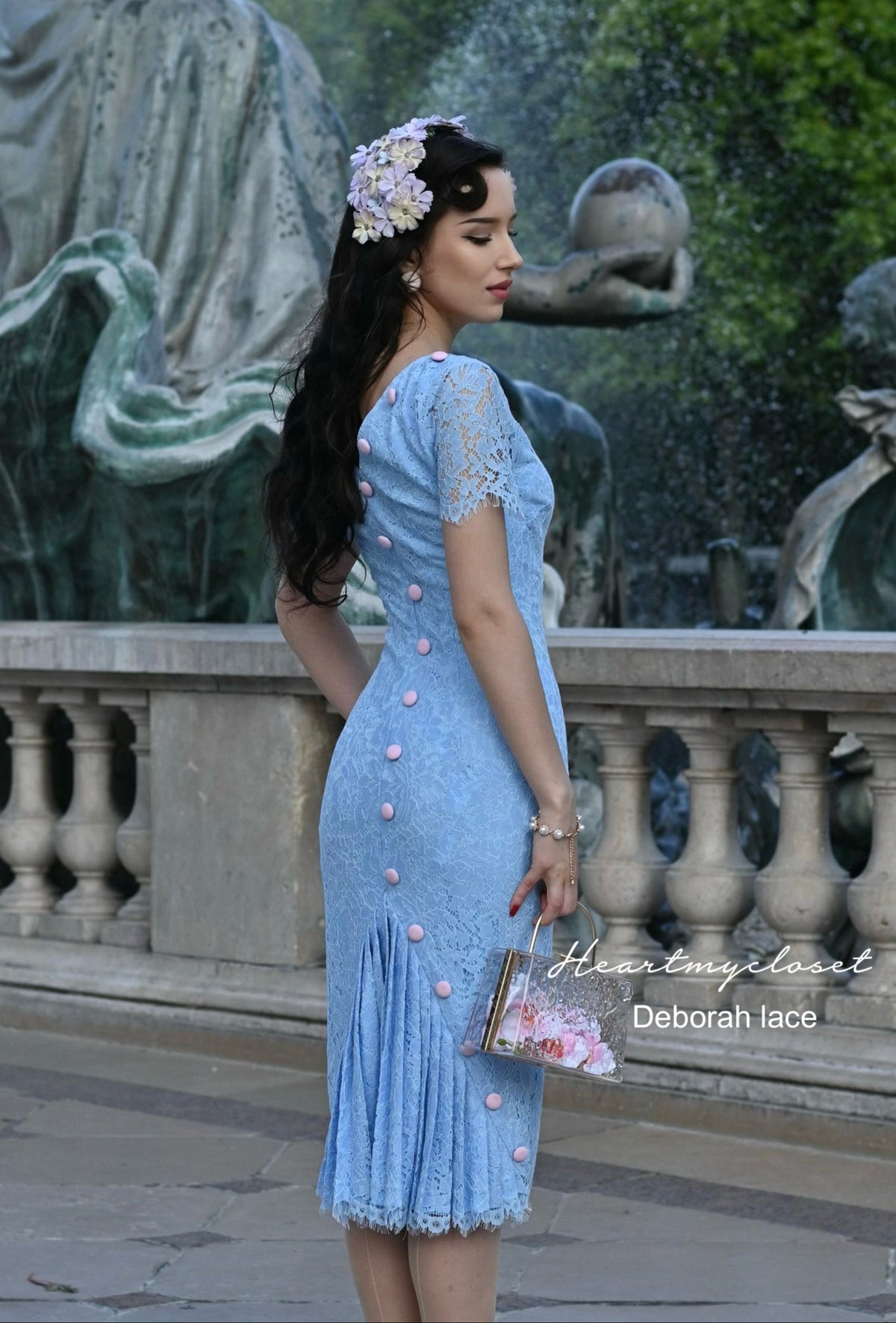 Woman in a light blue lace pencil dress 1950s inspired